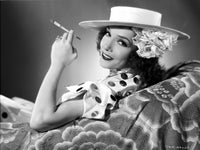 Lupe Velez smiling in polka dot dress holding a cigarette photo print