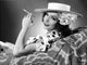 Lupe Velez smiling in polka dot dress holding a cigarette photo print