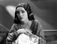 Lupe Velez posed in a checkered dress with a black scarf photo print