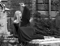 Veronica Carlson laying on concrete slab in flowing garment photo print