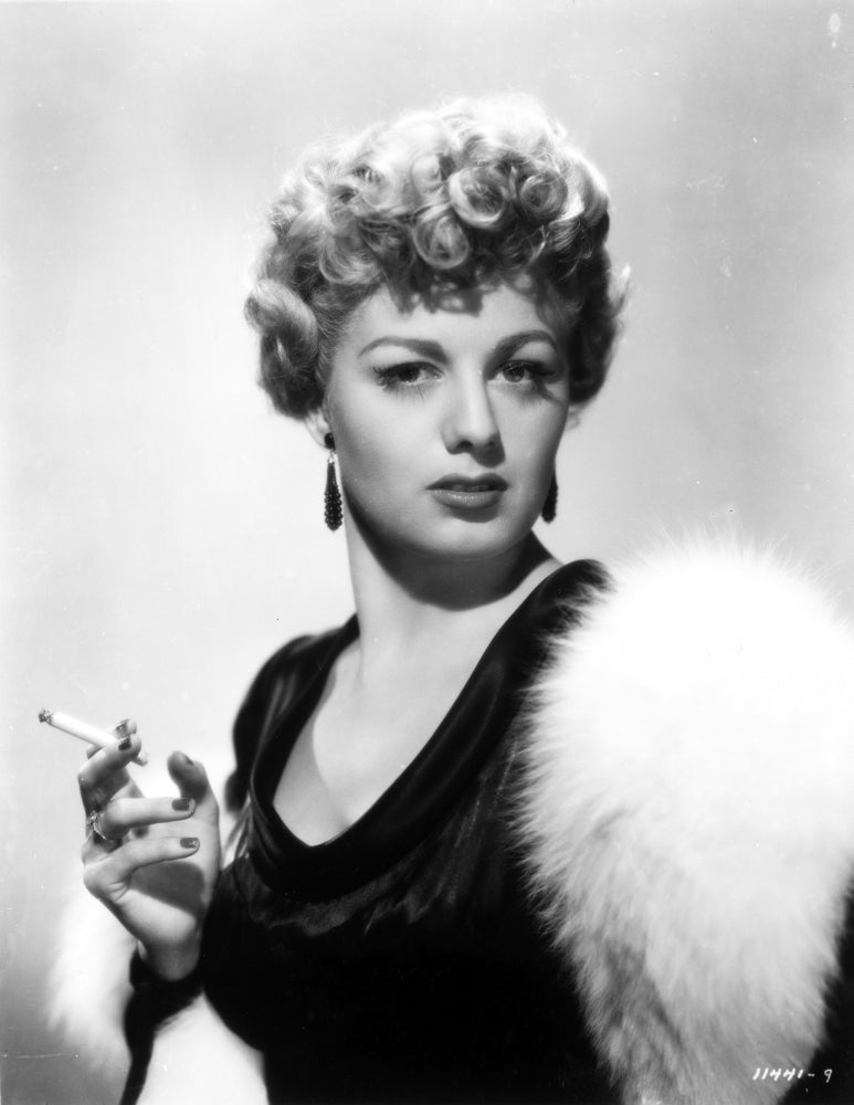 Classic photo print of Shelley Winters holding a cigarette.