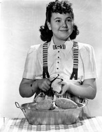 Jane Withers photo print in white short sleeve bodice peeling a potato