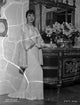 Anna Wong Leaning on a Table Photo Print in Long White Dress