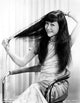 Anna Wong photo print sitting on a chair fixing her hair