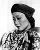 Anna Wong wearing a floral dress and beret photo print.