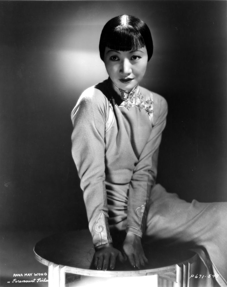 Anna Wong sitting on a small table photo print