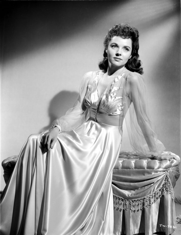 Jane Wyatt seated on a couch in a white silk dress photo print