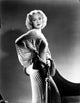 Photo print of Jane Wyman in a white corduroy dress, showcasing vintage elegance.