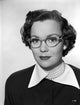 Jane Wyman portrait in black long sleeve shirt, white collar, and pearl accessories photo print.
