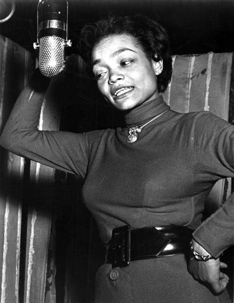 Eartha Kitt singing in a classic photo print, showcasing her iconic performance.