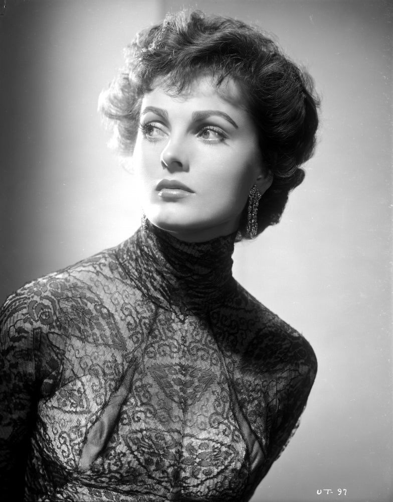 Ursula Theiss peering away in an intricate lace dress photo print.
