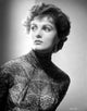 Ursula Theiss peering away in an intricate lace dress photo print.