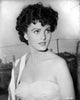 Ursula Theiss wearing a sweetheart bodice with a towel over her shoulder, looking away from the camera.