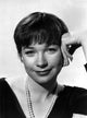 Shirley MacLaine portrait photo print in black V-neck shirt and pearl necklace