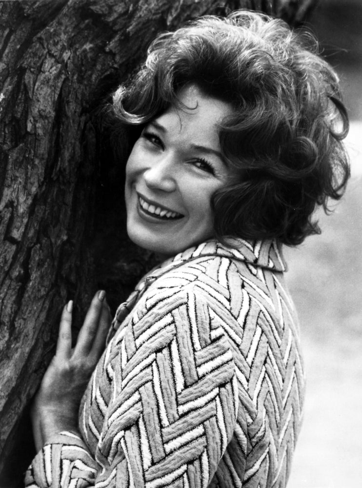 Shirley MacLaine leaning and smiling on a tree photo print