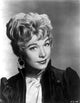 Shirley MacLaine portrait in black dress with hoop earrings photo print.