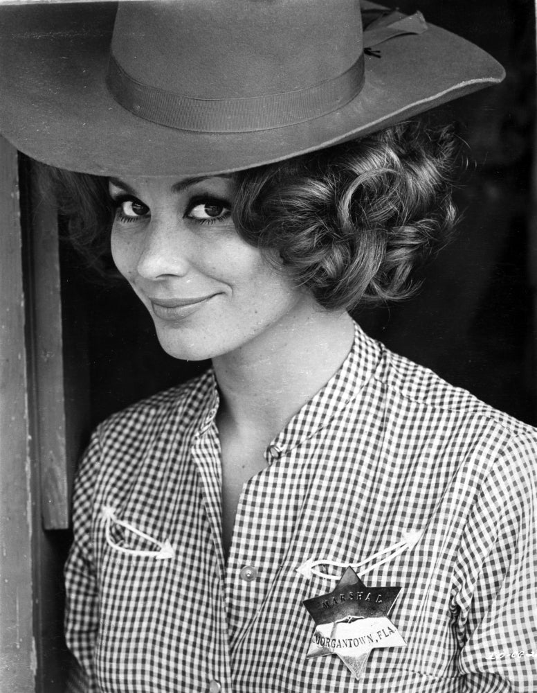 Irina Demick wearing a checkered polo with a hat photo print.