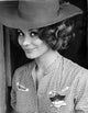 Irina Demick wearing a checkered polo with a hat photo print.