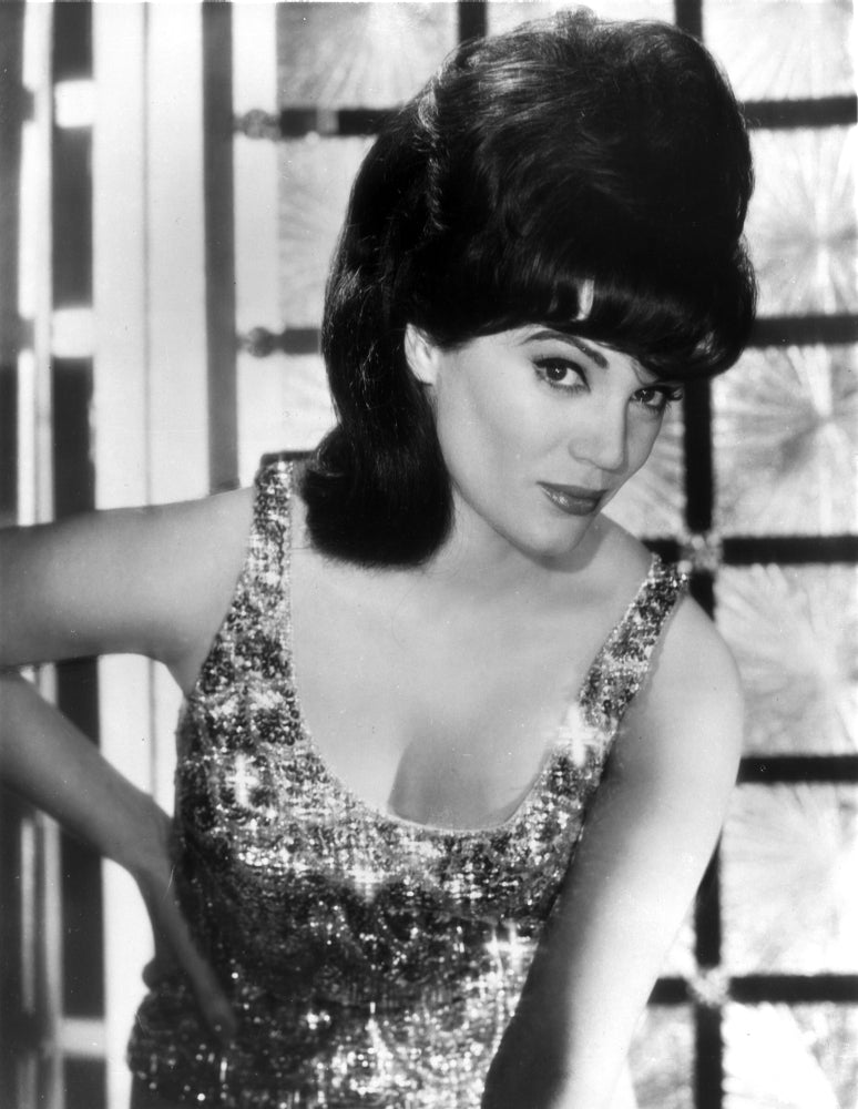 Connie Francis photo print in glossy tank top with hand on hips.