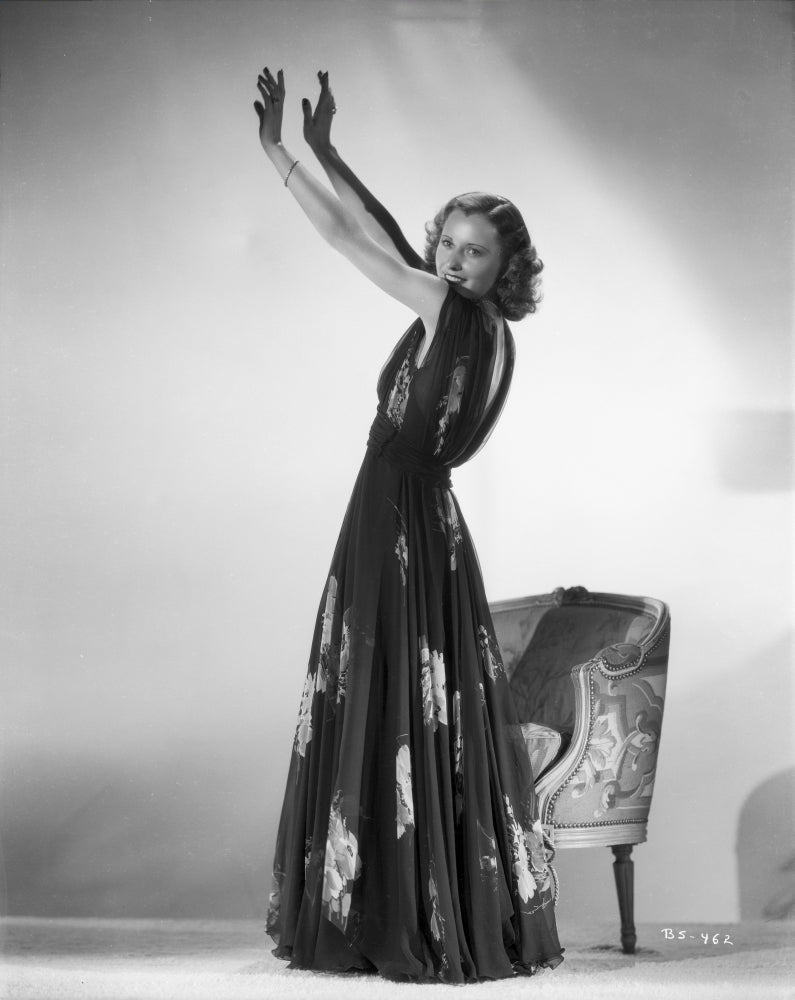 Classic portrait photo print of Barbara Stanwyck standing in a dress