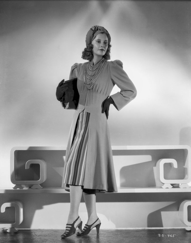 Classic portrait photo print of Barbara Stanwyck in dress with gloves and cap.
