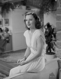 Barbara Stanwyck classic portrait photo print in a sitting pose.