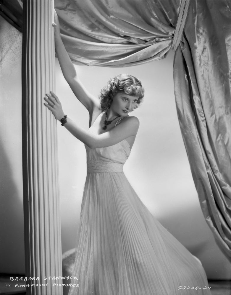 Barbara Stanwyck leaning in a long white gown photo print