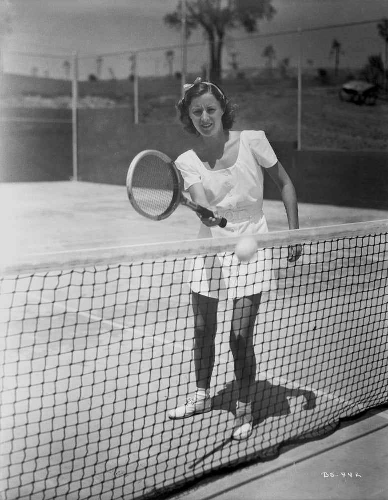 Black and white portrait of Barbara Stanwyck playing tennis, photo print.