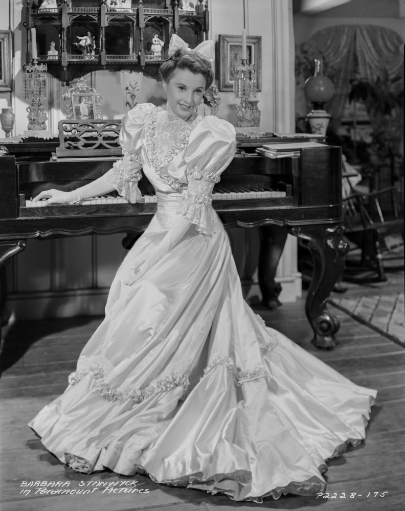 Barbara Stanwyck standing in glossy long dress classic portrait photo print.