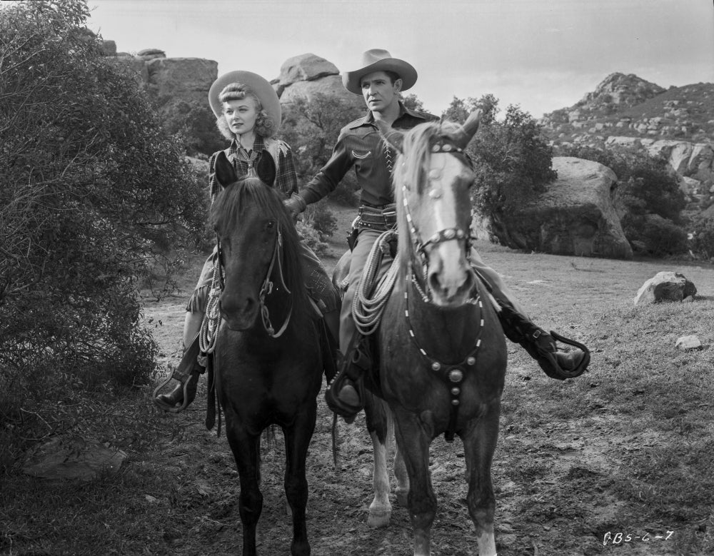 Film still featuring Bob Steele and a woman riding horses photo print.