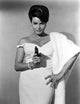 Senta Berger photo print in white dress with a pistol.