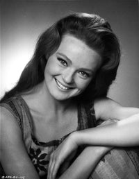 Photo print of Katharine Houghton smiling in a mini skirt.