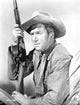 James Stewart in leather jacket holding a shotgun photo print