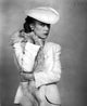 Sissy Spacek wearing white tunic with fur scarf in classic portrait photo print.