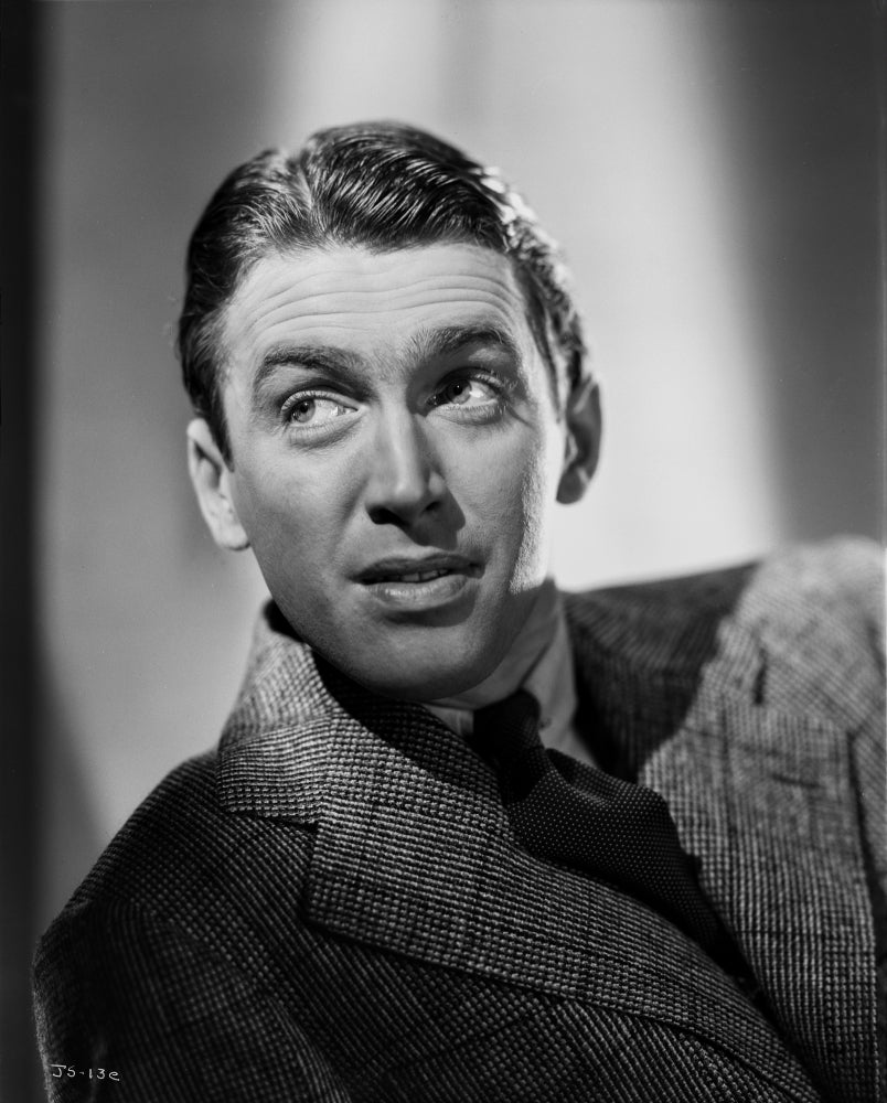 James Stewart portrait in grey suit and necktie looking up to the right