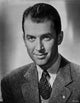 James Stewart portrait in grey tweed sport coat and black necktie with white collar shirt photo print.