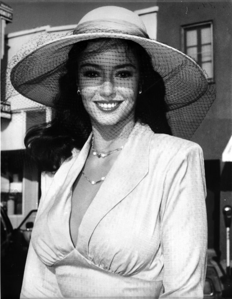 Rachel Ward portrait photo print wearing a netted sun hat outdoors
