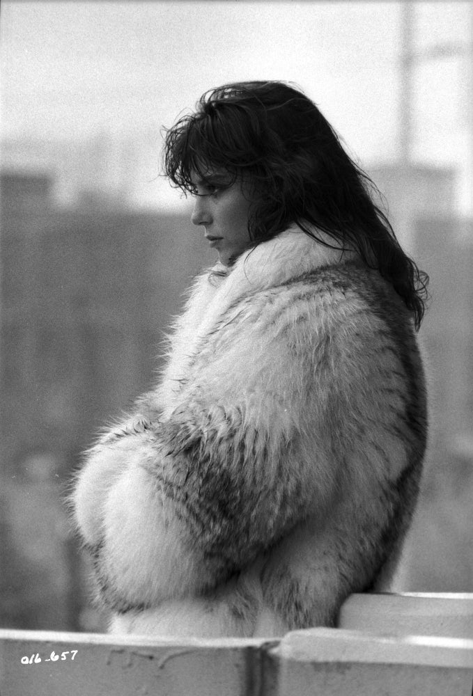 Rachel Ward candid portrait wearing a fur coat in black and white photo print.