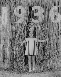 Shirley Temple wearing a white tent dress in a classic portrait photo print.