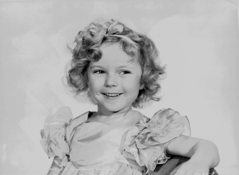 Shirley Temple wearing a cap-sleeve dress photo print.