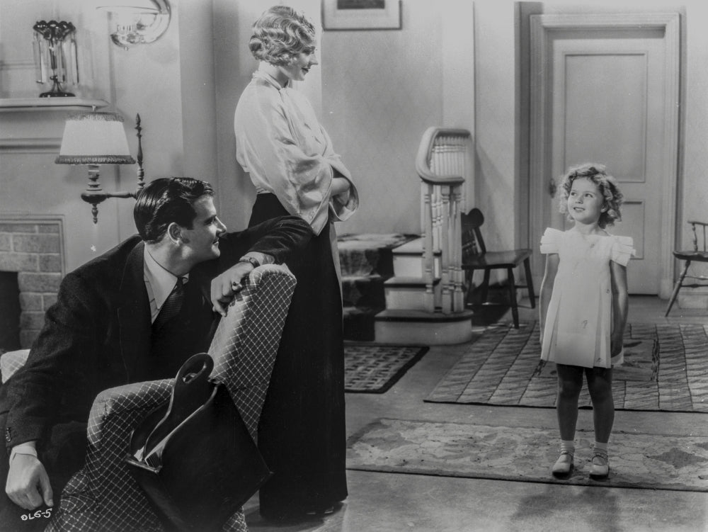 Shirley Temple talking with her parents in the living room photo print