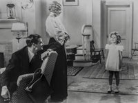 Shirley Temple talking with her parents in the living room photo print