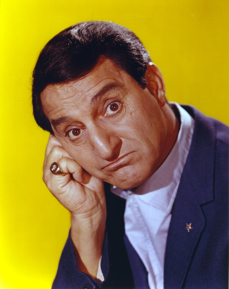 Danny Thomas photo print in black coat against yellow background.