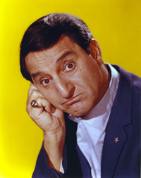 Danny Thomas photo print in black coat against yellow background.