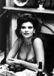 Lolita Davidovich seated in classic photo print showcasing elegance.