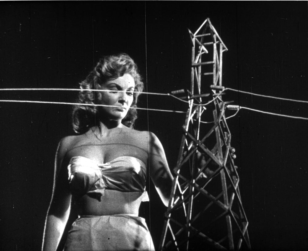 Alison Hayes publicity still next to a power pylon photo print.