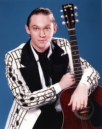 Richard Thomas holding a guitar in a white coat photo print.