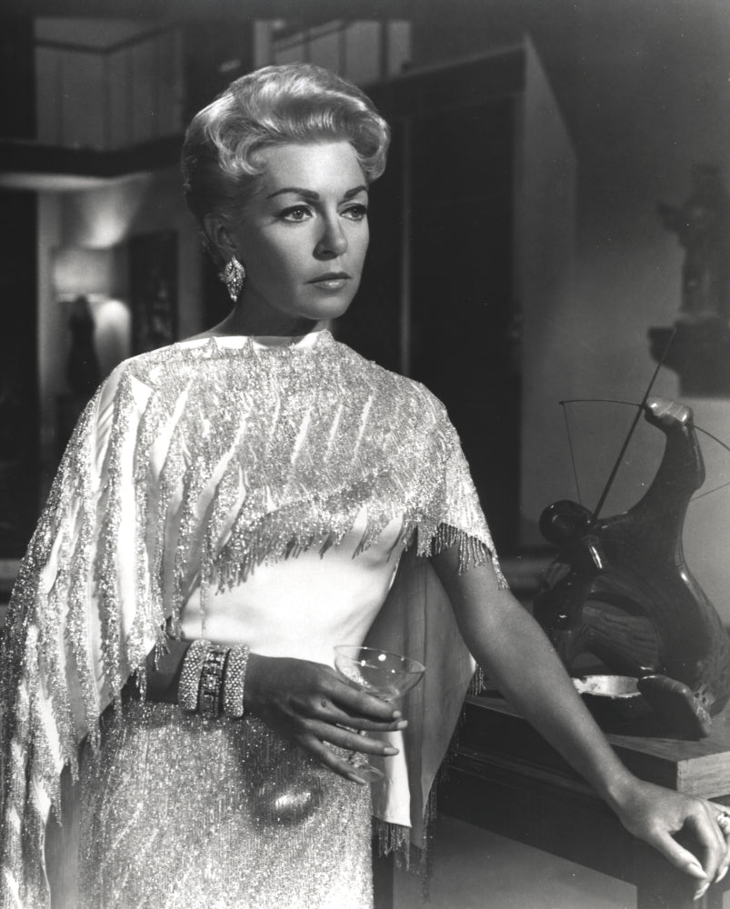 Portrait photo print of Lana Turner holding a wine glass in a white gown.