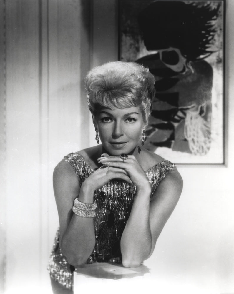 Black and white portrait of Lana Turner in a sparkling dress.