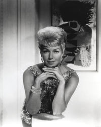 Black and white portrait of Lana Turner in a sparkling dress.